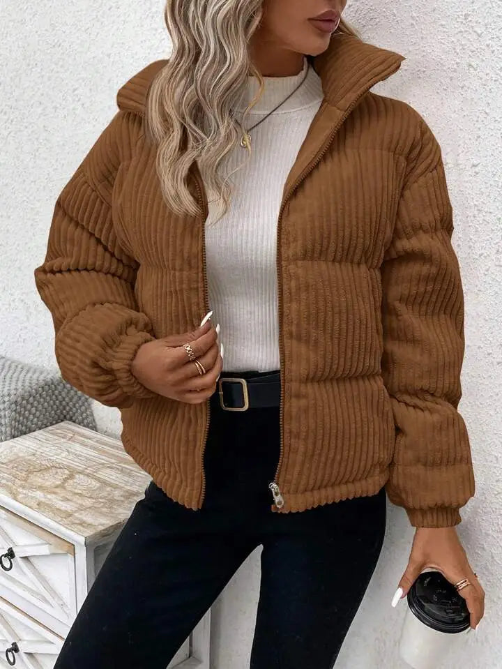 A cozy brown corduroy puffer jacket with a hood and zipper closure designed as a plus size women winter coat.