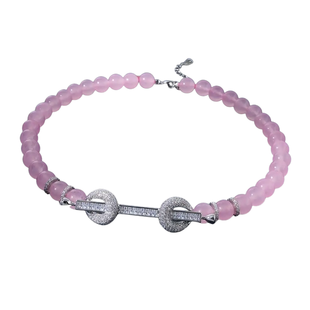 A delicate pink rose quartz beaded choker necklace with a silver-toned clasp featuring sparkling cubic zirconia
