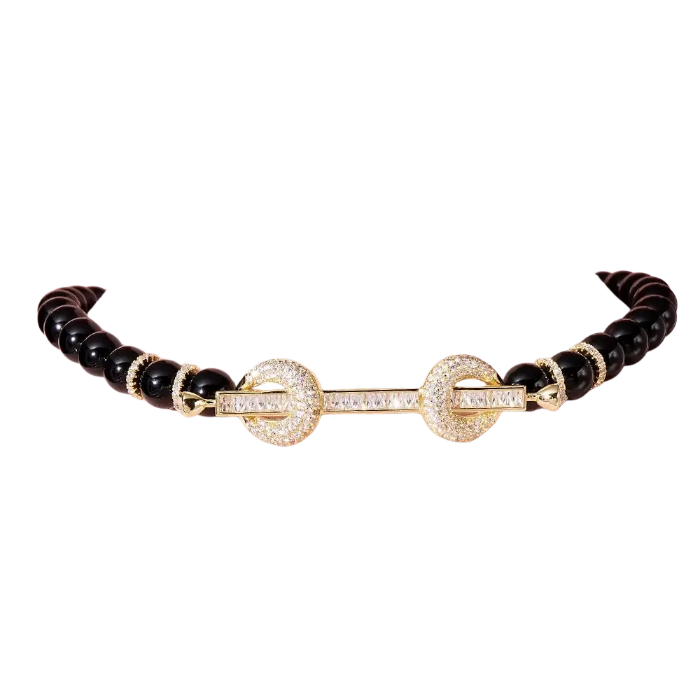 Elegant black beaded choker necklace with a gold-toned diamond-encrusted clasp featuring rectangular-cut stones