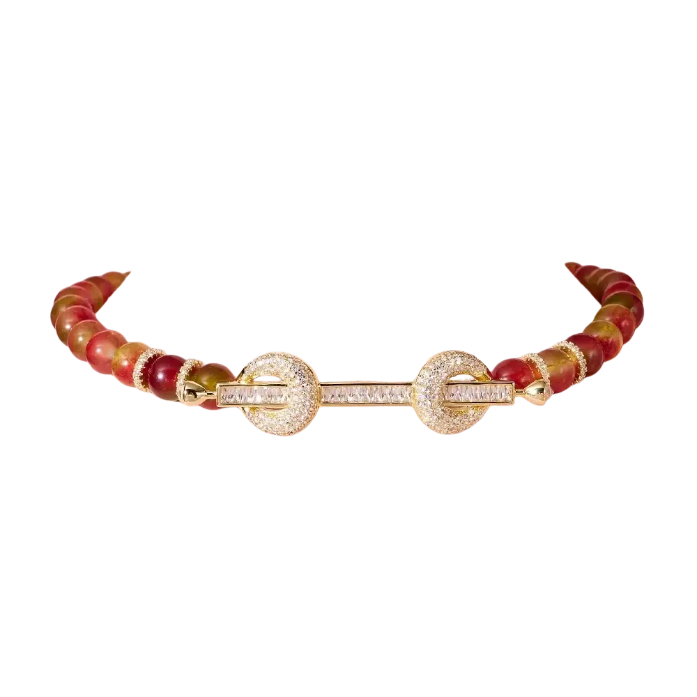 Beaded choker necklace with a gold-toned bar, cubic zirconia diamonds, and red amber-colored smooth beads