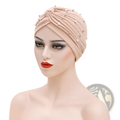 Beige beaded cotton turban hat for women with pearl and silver bead embellishments on the front side