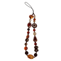 A beaded phone charm strap with amber orange and dark brown glass beads and intricate floral crystal designs