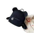 Black bear shaped plush backpack made of fuzzy fleece with soft texture and rounded ears for cute rucksack use