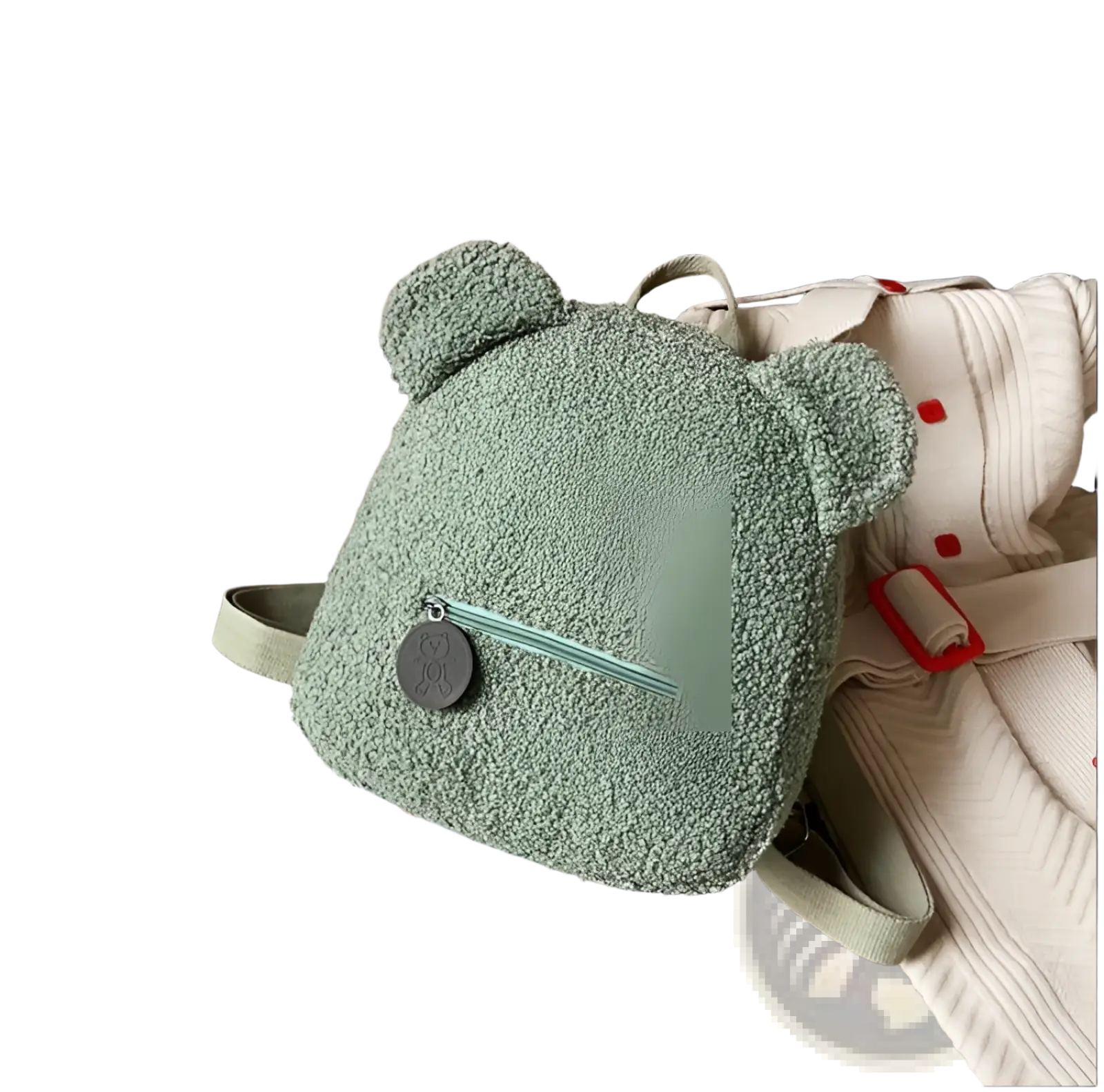 Soft mint green bear shaped plush backpack with fuzzy fleece material and small circular metal charm on front zipper