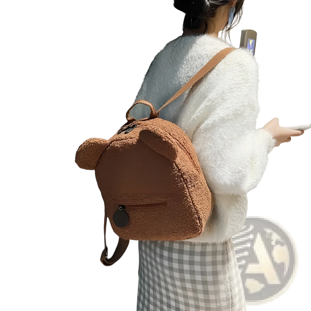 A cozy brown teddy bear-shaped plush backpack with soft fuzzy fleece material and stitched ear details