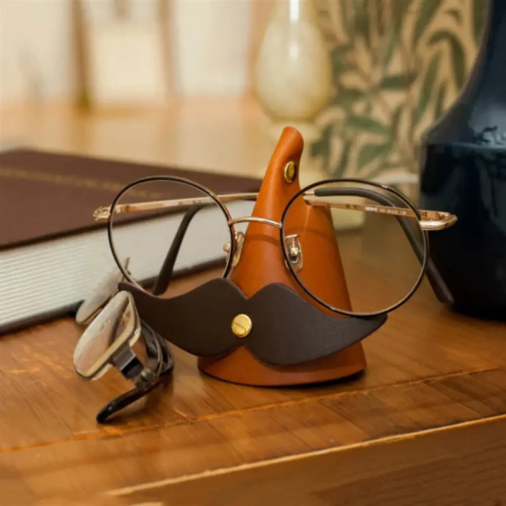 Handmade mustache leather eyeglasses holder stand in brown with gold-tone hardware for stylish eyewear storage