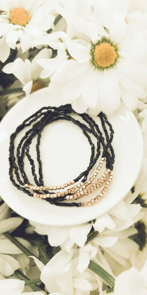 Elegant black and rose gold layered beaded bracelet set featuring a multi-strand wrap design with contrasting beads