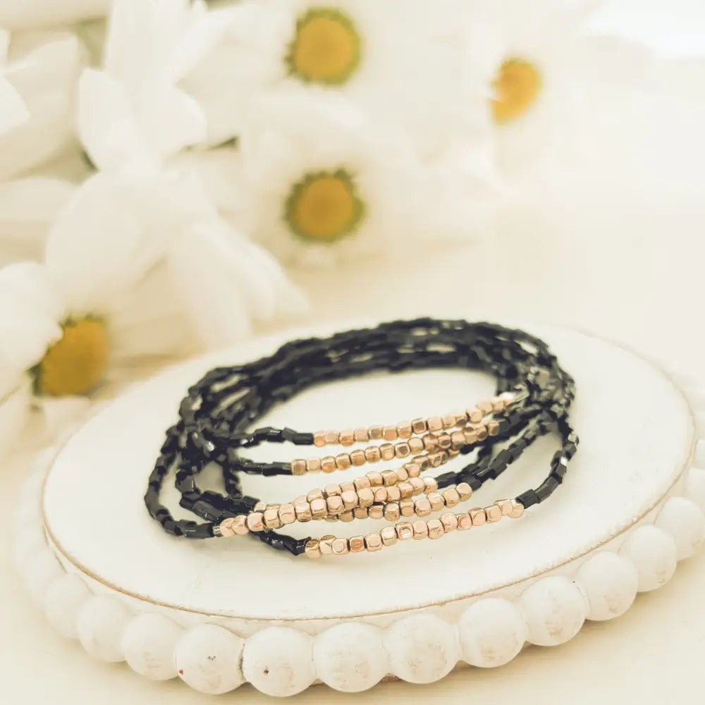 Elegant black and rose gold layered beaded bracelet set featuring delicate, wrap design with black and rose gold beads