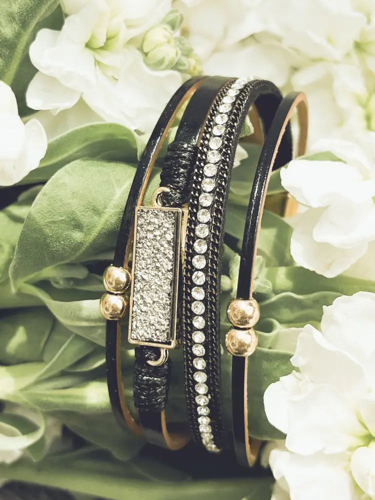 Crystal layered black leather bracelet with multi-strand wrap, gold-toned beads, and rectangular crystal-embellished plate
