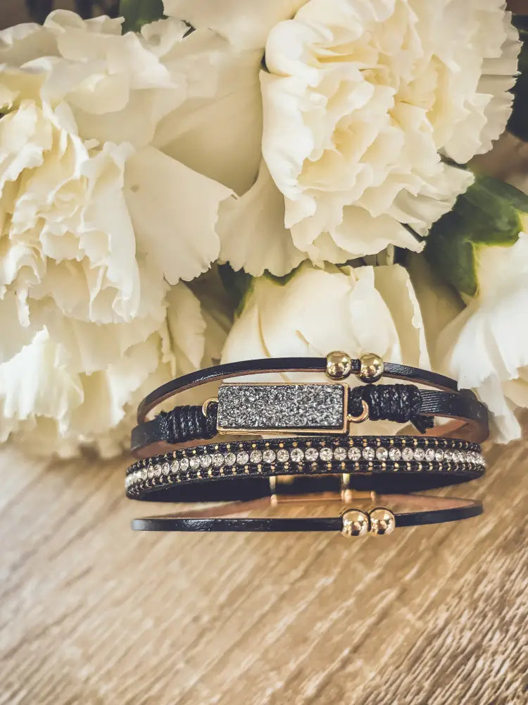Crystal layered black leather bracelet featuring a gold-toned rectangular druzy stone and clear rhinestone accents