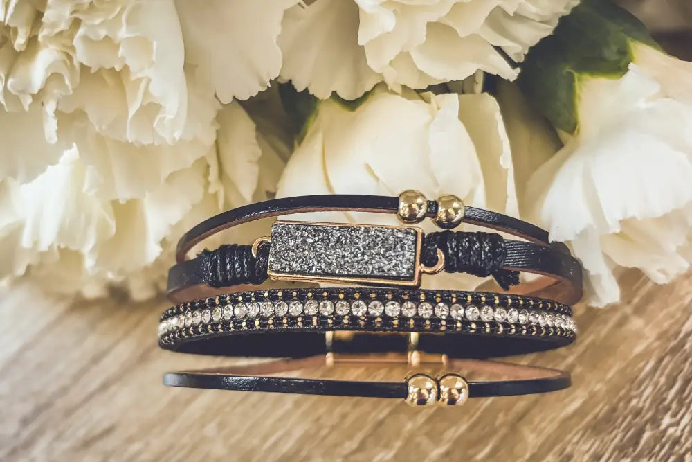 Crystal layered black leather bracelet with gold-toned rectangular druzy stone and rhinestone-studded band centerpiece