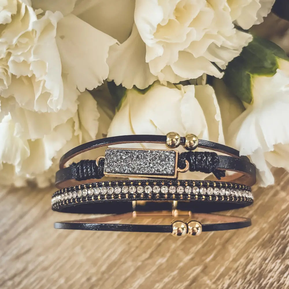 Crystal layered black leather bracelet with gold accents featuring a multi-strand wrap design and druzy stone centerpiece
