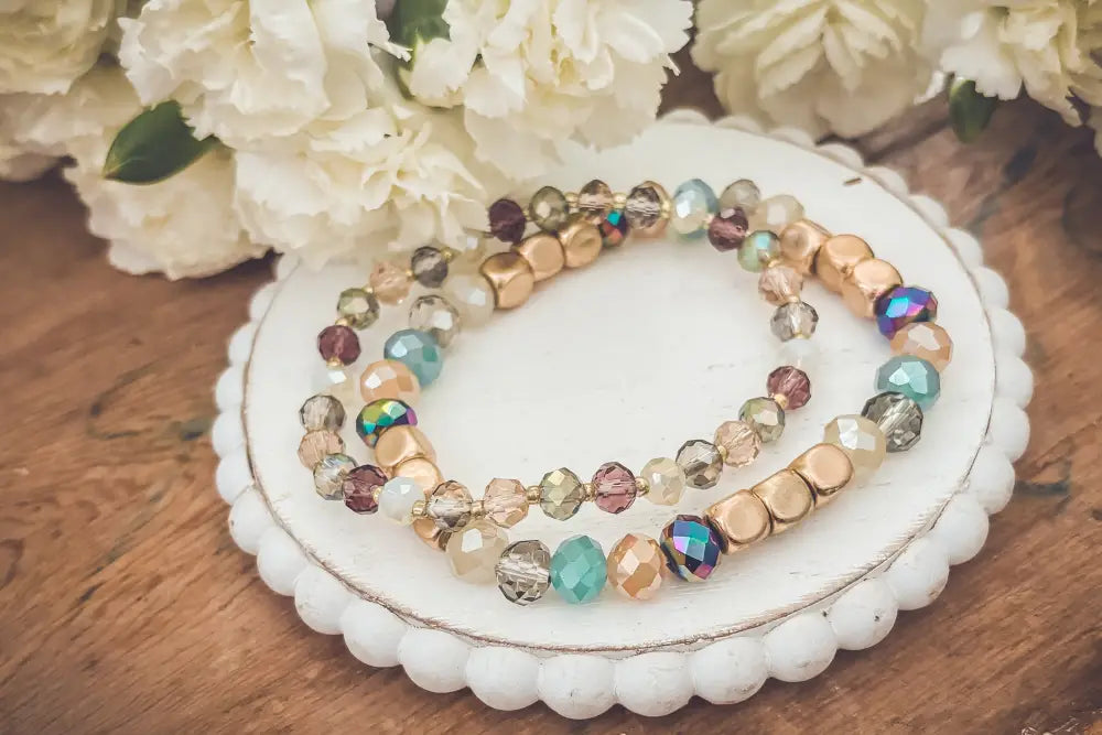 Bohemian earth tone iridescent beaded stacking bracelet featuring gold-toned beads and multicolor faceted crystals
