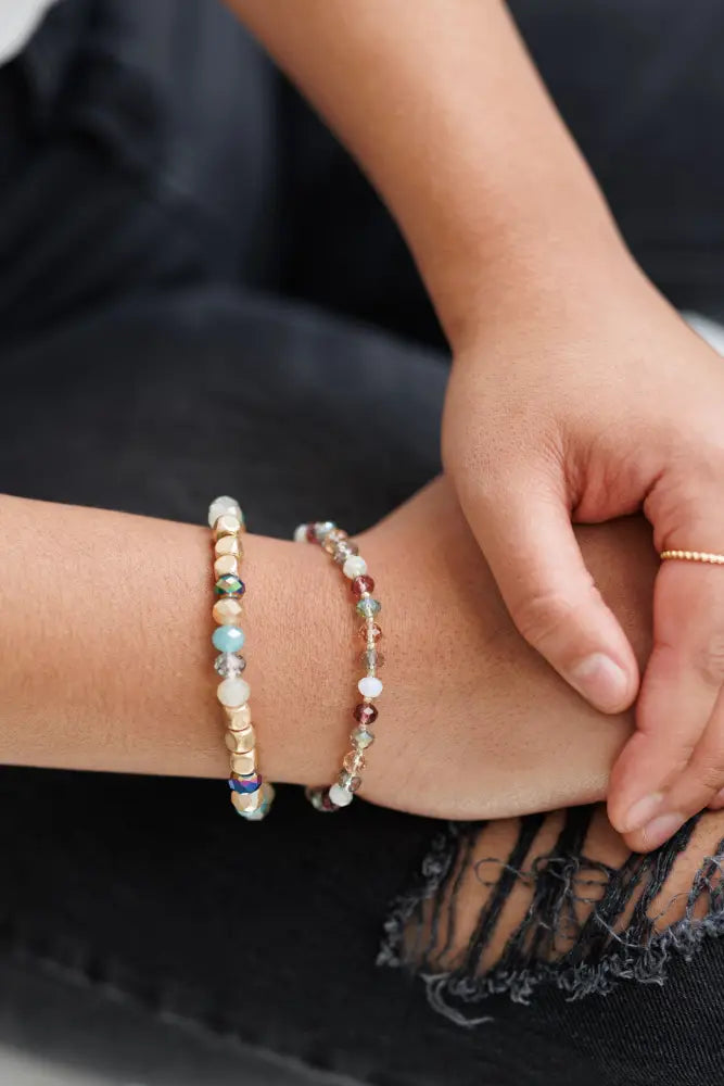 Two delicate bohemian earth tone iridescent beaded stacking bracelets with gold accents and pastel translucent gemstones