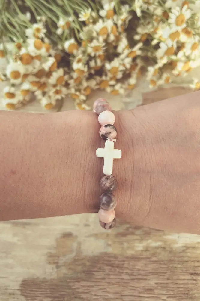 Pink and gray marbled cross stone stacking bracelet with delicate beads and a central white cross charm