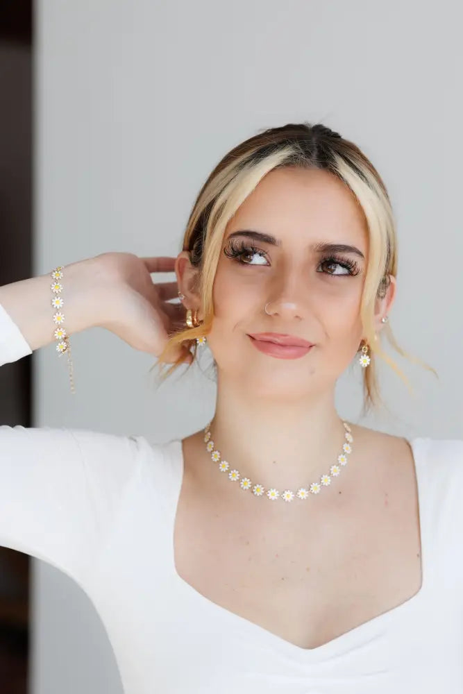 Gold daisy enamel necklace and earrings set featuring a delicate gold chain and small flower charms
