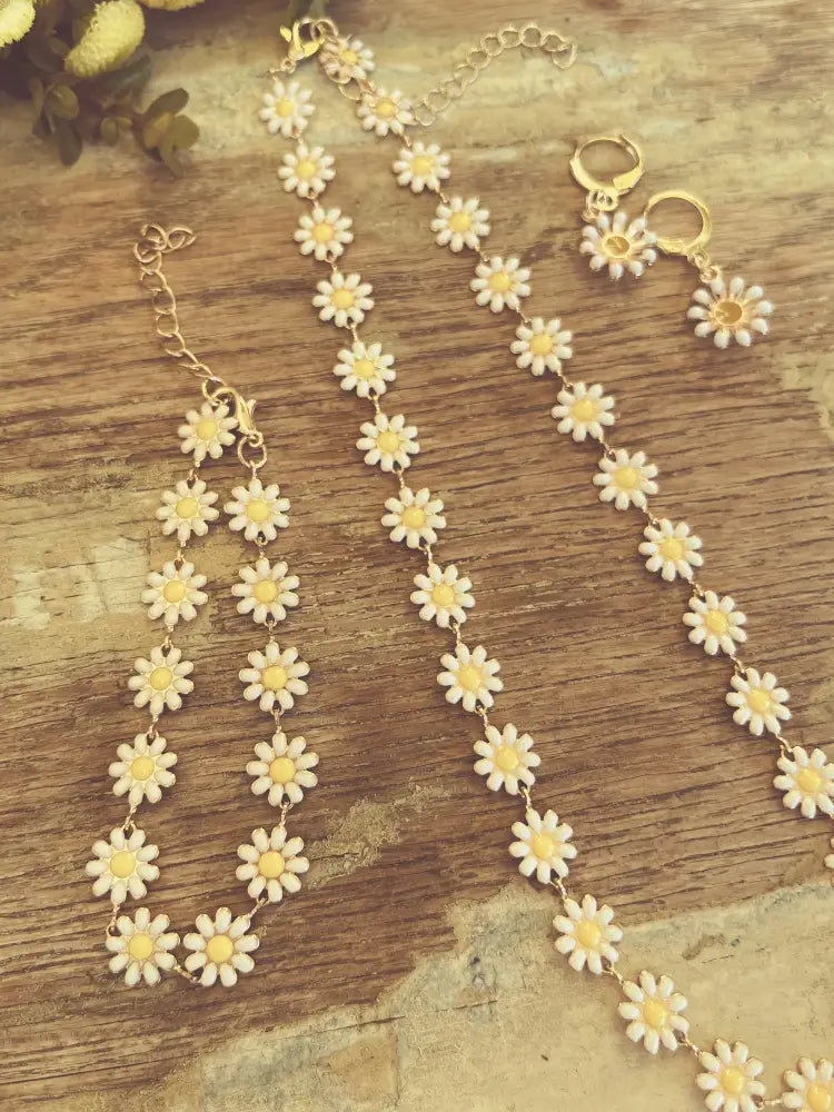 Gold daisy enamel necklace and earrings set with gold tone metal white enamel petals and yellow centers