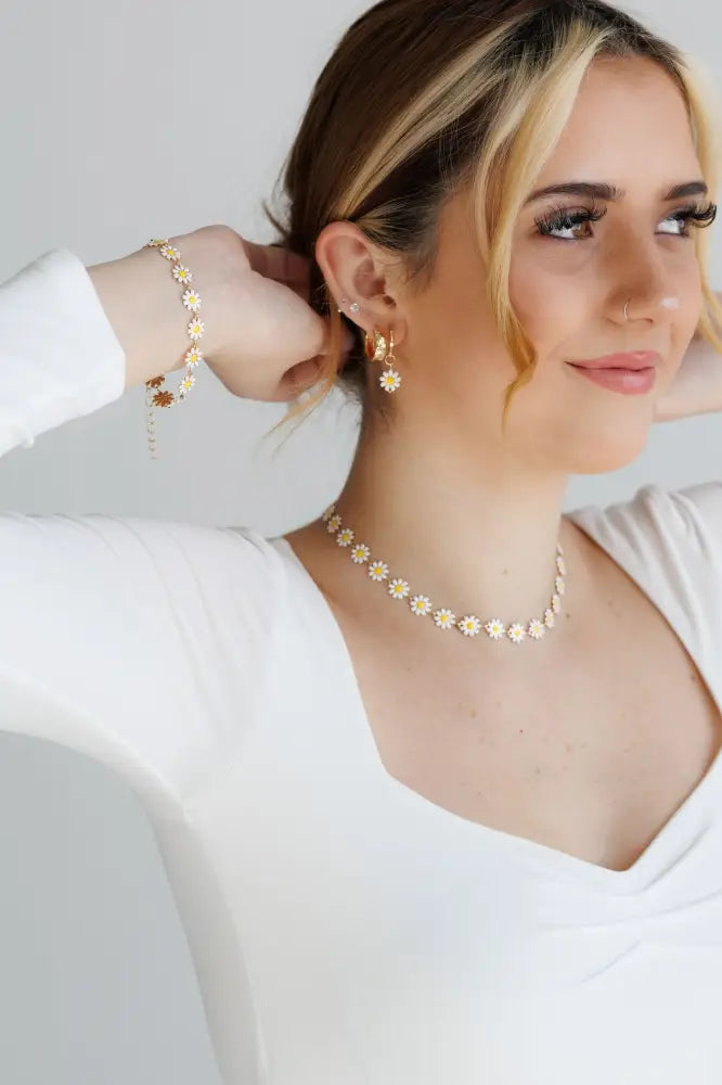 Gold daisy enamel necklace and earrings jewelry set featuring a delicate gold chain and matching floral earrings