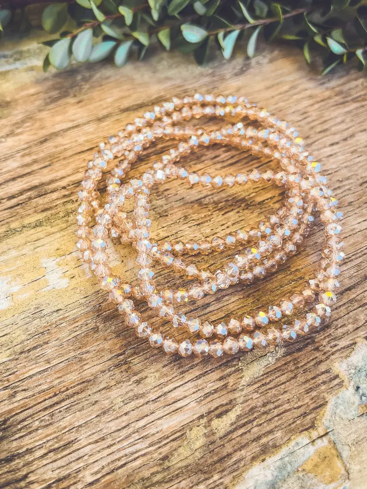 Rose gold multi strand faceted crystal bead bracelet with delicate champagne faceted beads and subtle iridescent shimmer