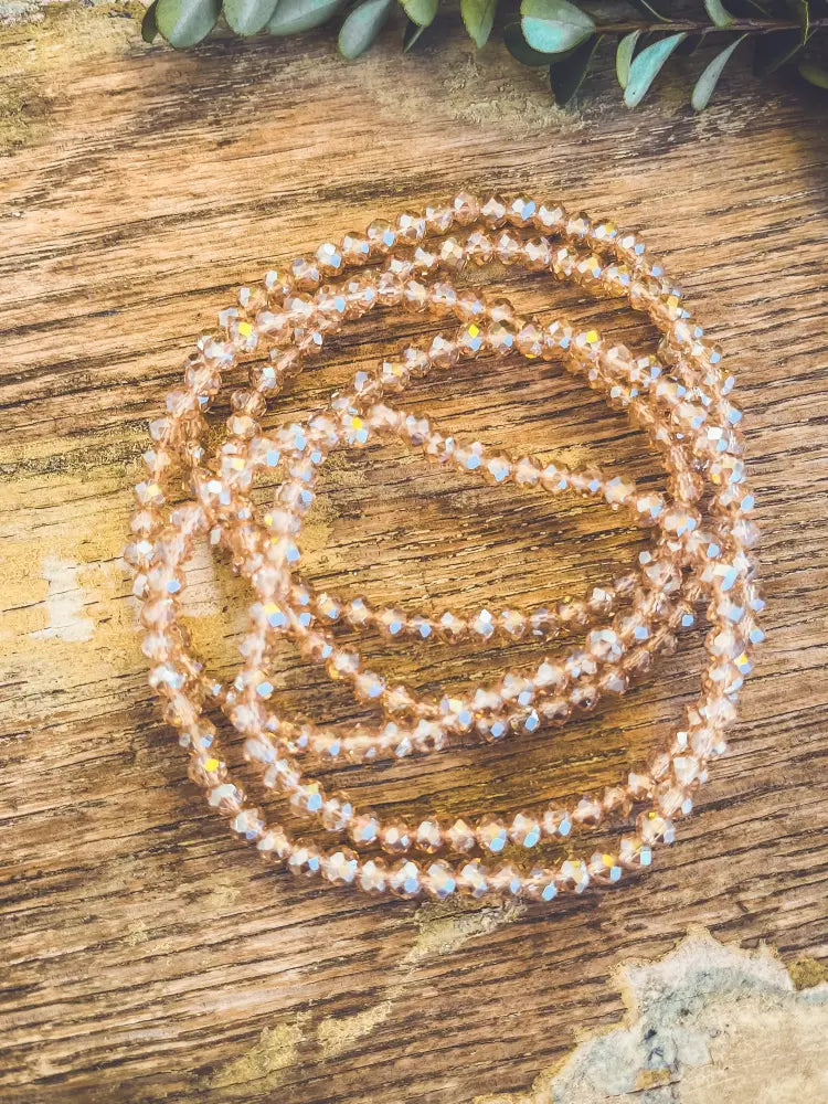 Rose gold multi strand bracelet with faceted crystal beads that catch the light in a delicate design