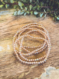 A delicate rose gold multi strand bracelet made of faceted crystal beads for elegant wear