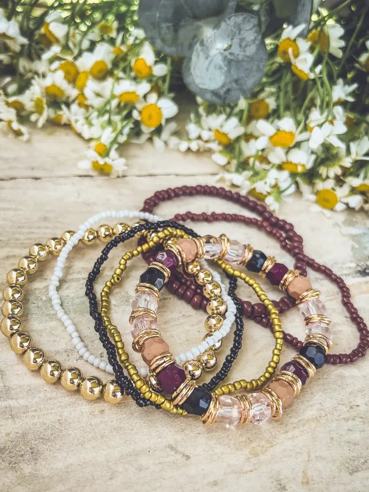 Gold and burgundy earthy beaded stacking bracelet set with stretch design and clear crystal accents in gold white black tones