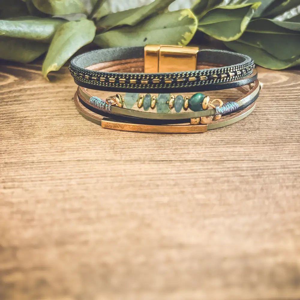 Layered green gemstone and leather magnetic bracelet with multi-layered leather, turquoise accents, and gold-toned clasp