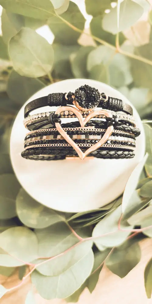 Layered black leather and rose gold heart druzy bracelet with braided straps beaded accents and central crystal embellishment
