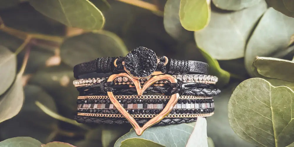 Layered black leather bracelet with rose gold heart druzy charm and sparkling embellishments for stylish wear