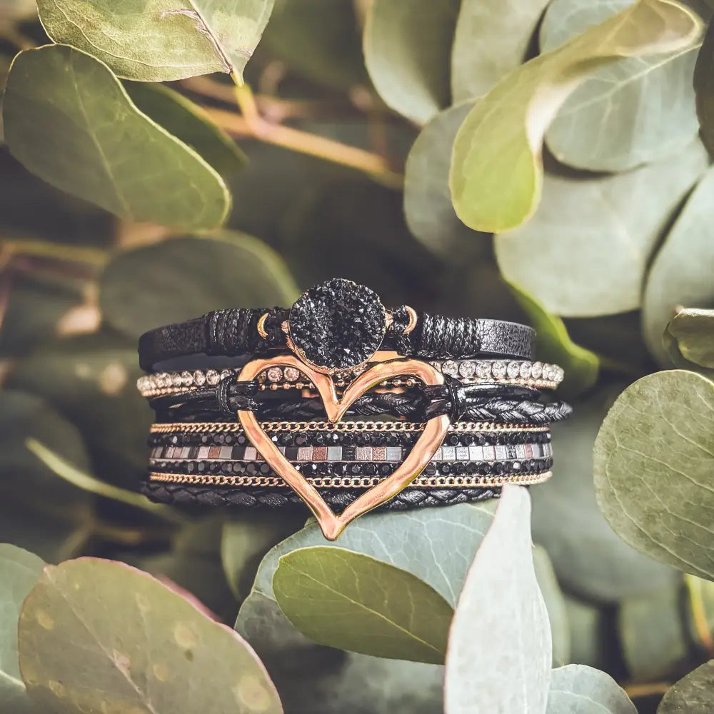 Layered black leather wrap bracelet with rose gold heart charm and dark textured druzy stone centerpiece