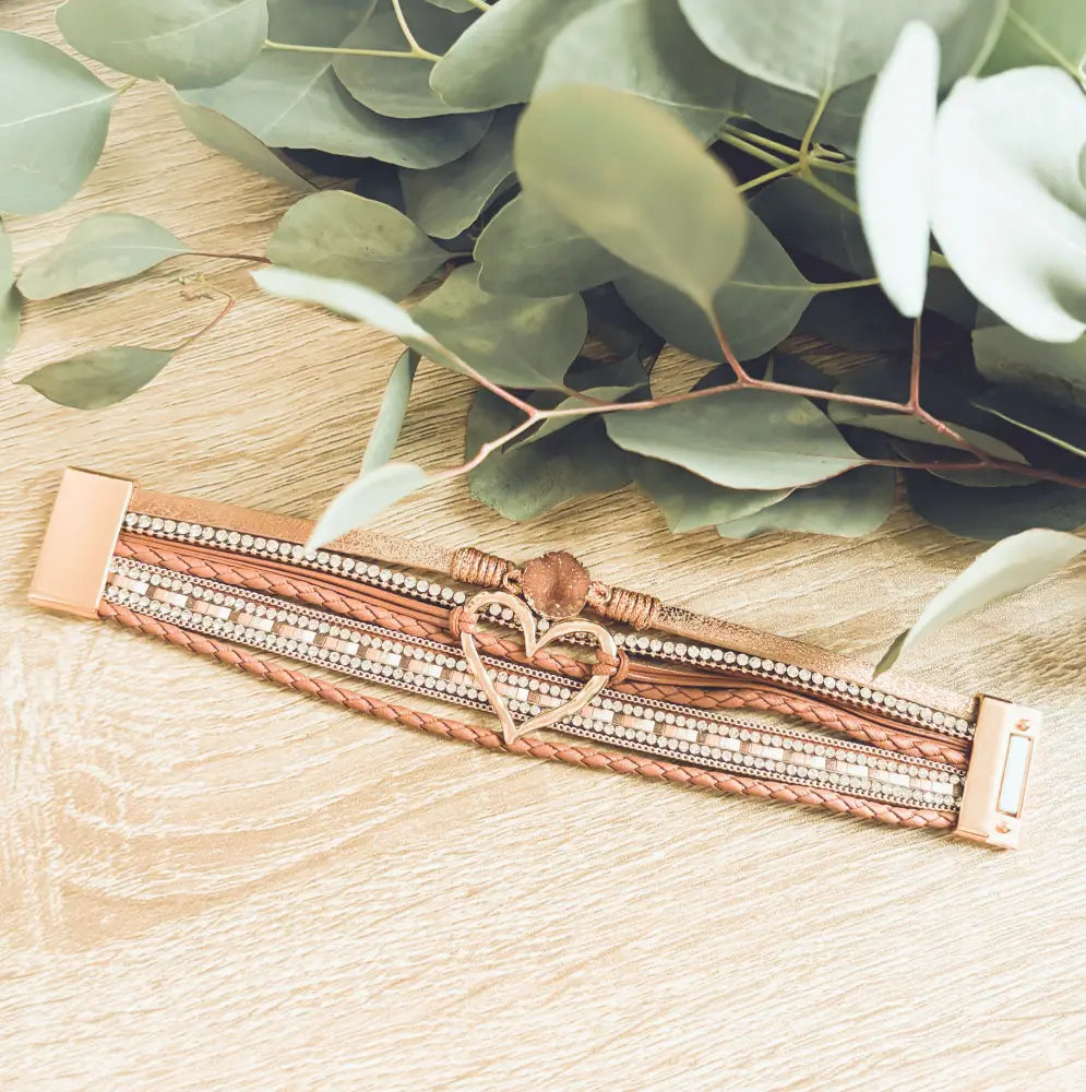 Rose gold braided leather heart charm bracelet with crystals featuring multi-strand brown leather and metallic accents