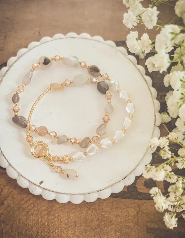 Pearl and crystal beaded gold charm bracelet with translucent and opaque earthy stones and gold-toned accents