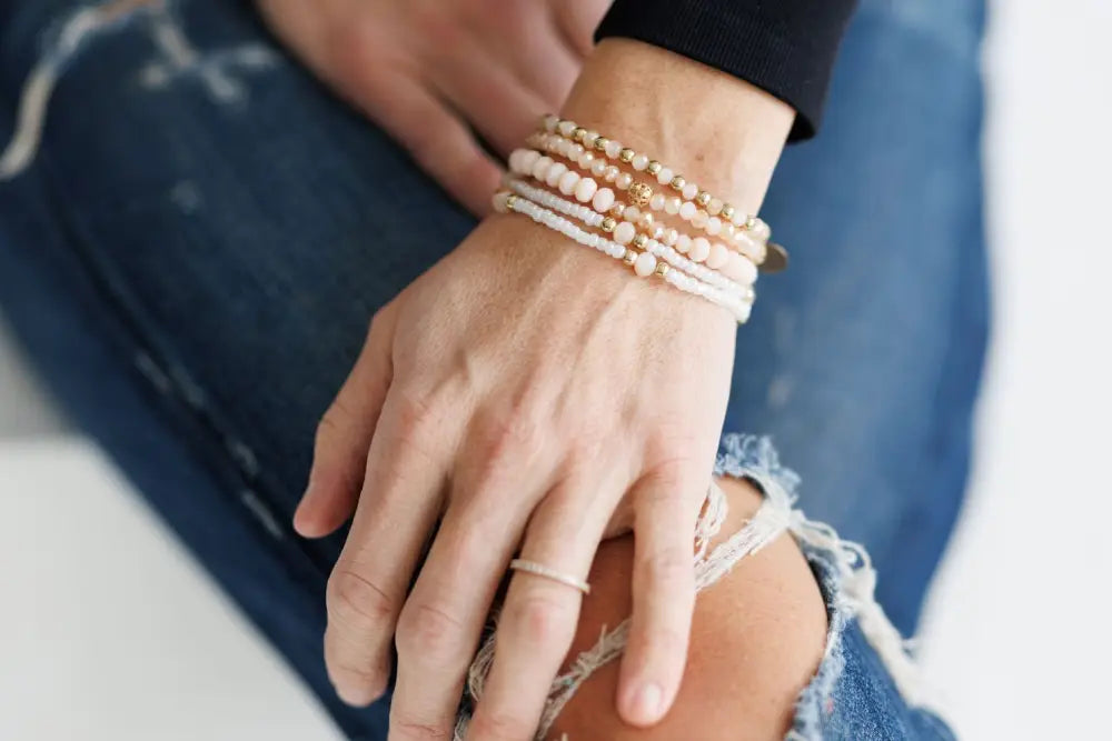 Elegant pink and gold beaded stacking bracelet set with delicate round beads and subtle metallic accents
