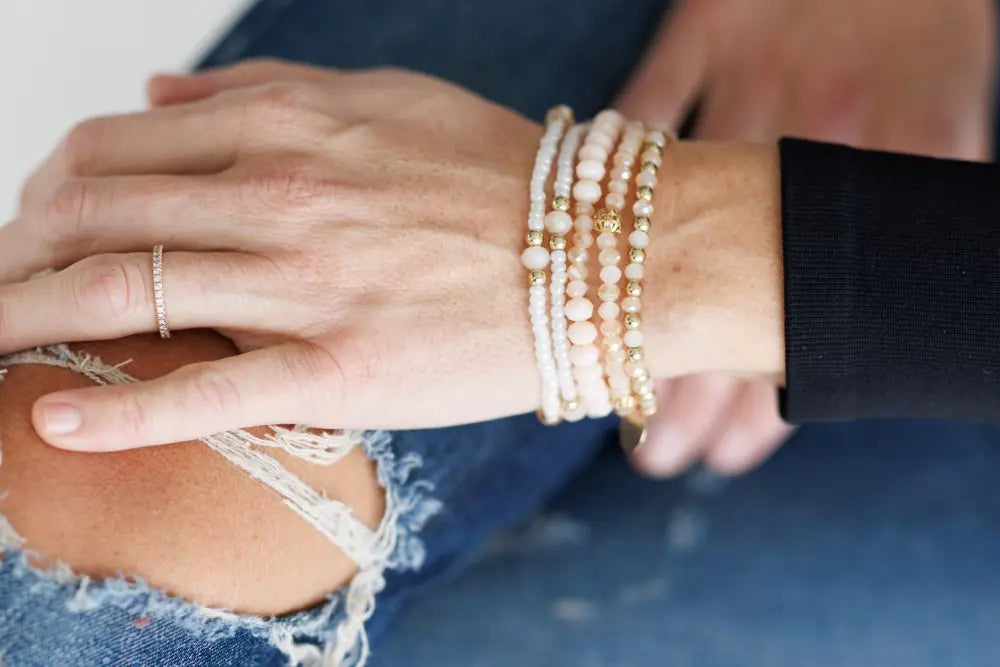 Elegant pink and gold beaded stacking bracelet set with delicate cream and gold round beads and metallic accents