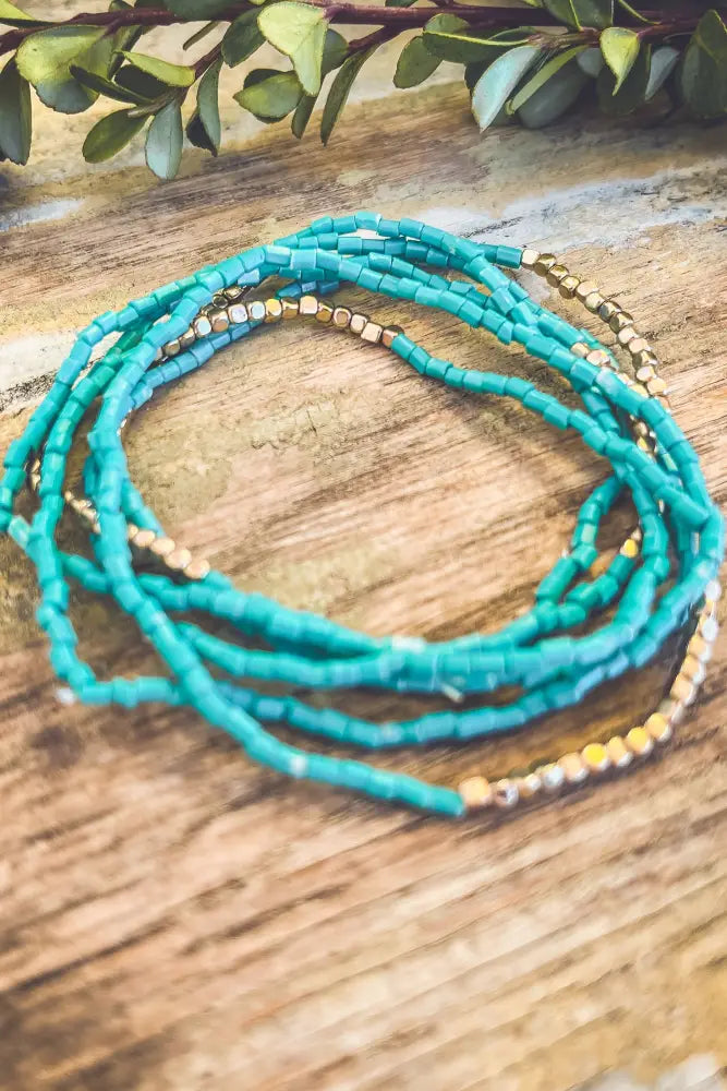 Boho turquoise and gold beaded stacking wrap bracelet featuring turquoise beads and gold-toned accents
