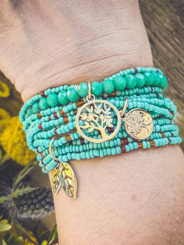 Turquoise tree of life beaded wrap bracelet set with gold toned tree of life and floral charms in turquoise beads
