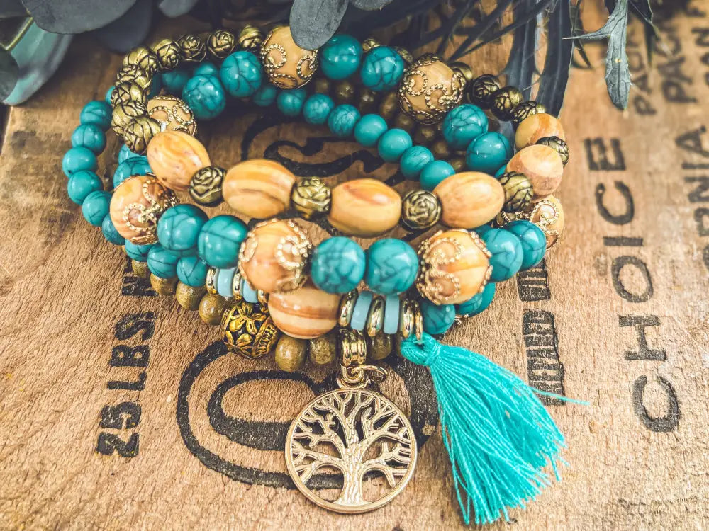 Turquoise tree of life and wood beaded bracelet set with gold-toned beads and matching tassel charm