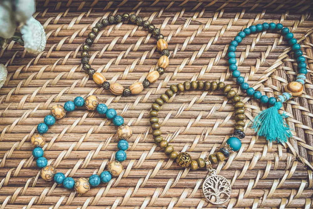 Three handcrafted turquoise tree of life and wood beaded bracelets with gold brown tones and tassel accents