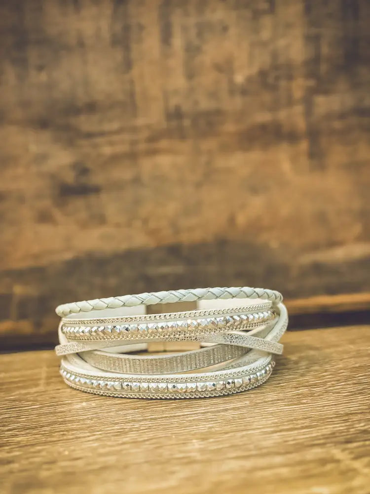 White layered leather wrap bracelet featuring silver-toned beaded and textured accents in white leather