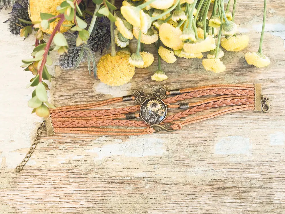 You are my sunshine braided leather bracelet featuring a rustic multi strand design with bronze sunflower and gear charm