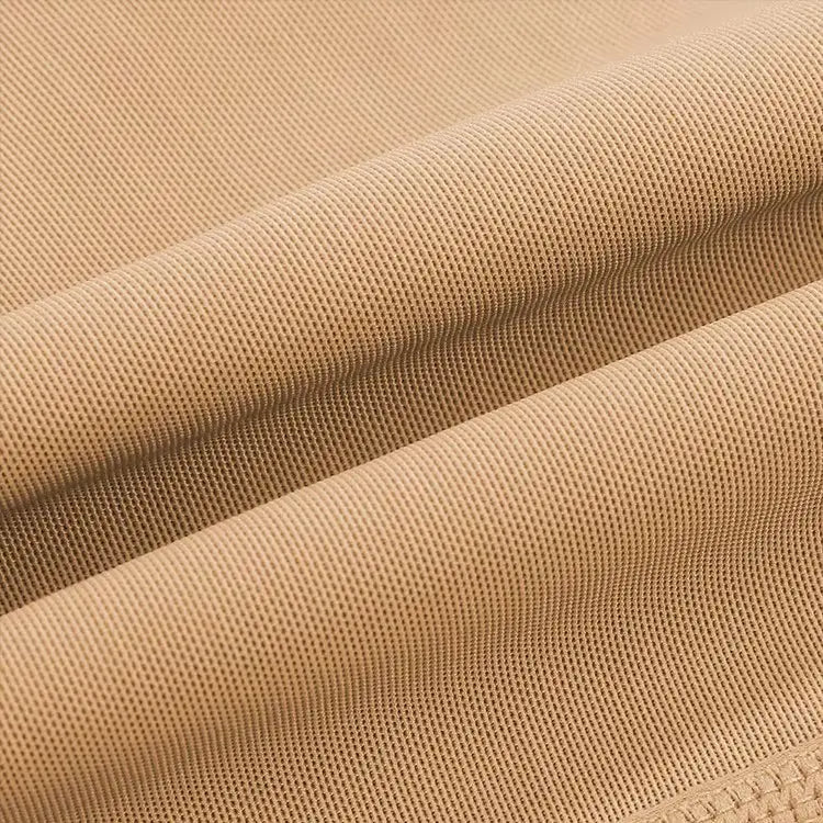 Tan-colored high waist shapewear shorts with a textured fabric and subtle woven pattern designed as lace butt enhancer visible from the back side.