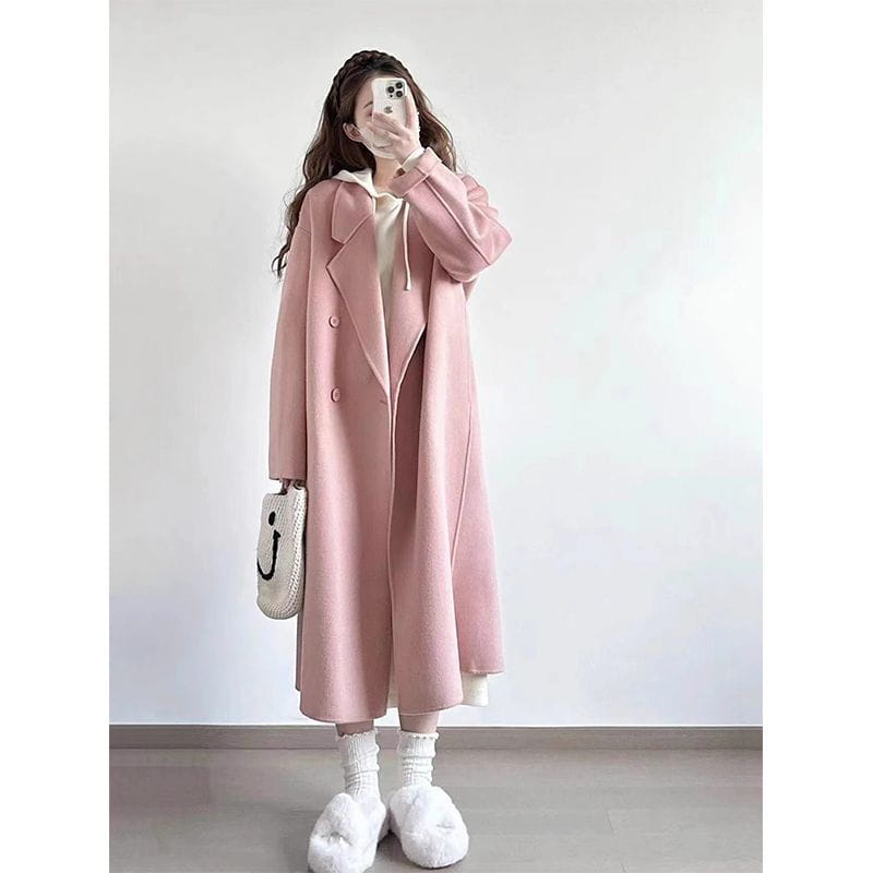 A soft pink longline wool trench coat petite featuring a classic double-breasted design and a hood.