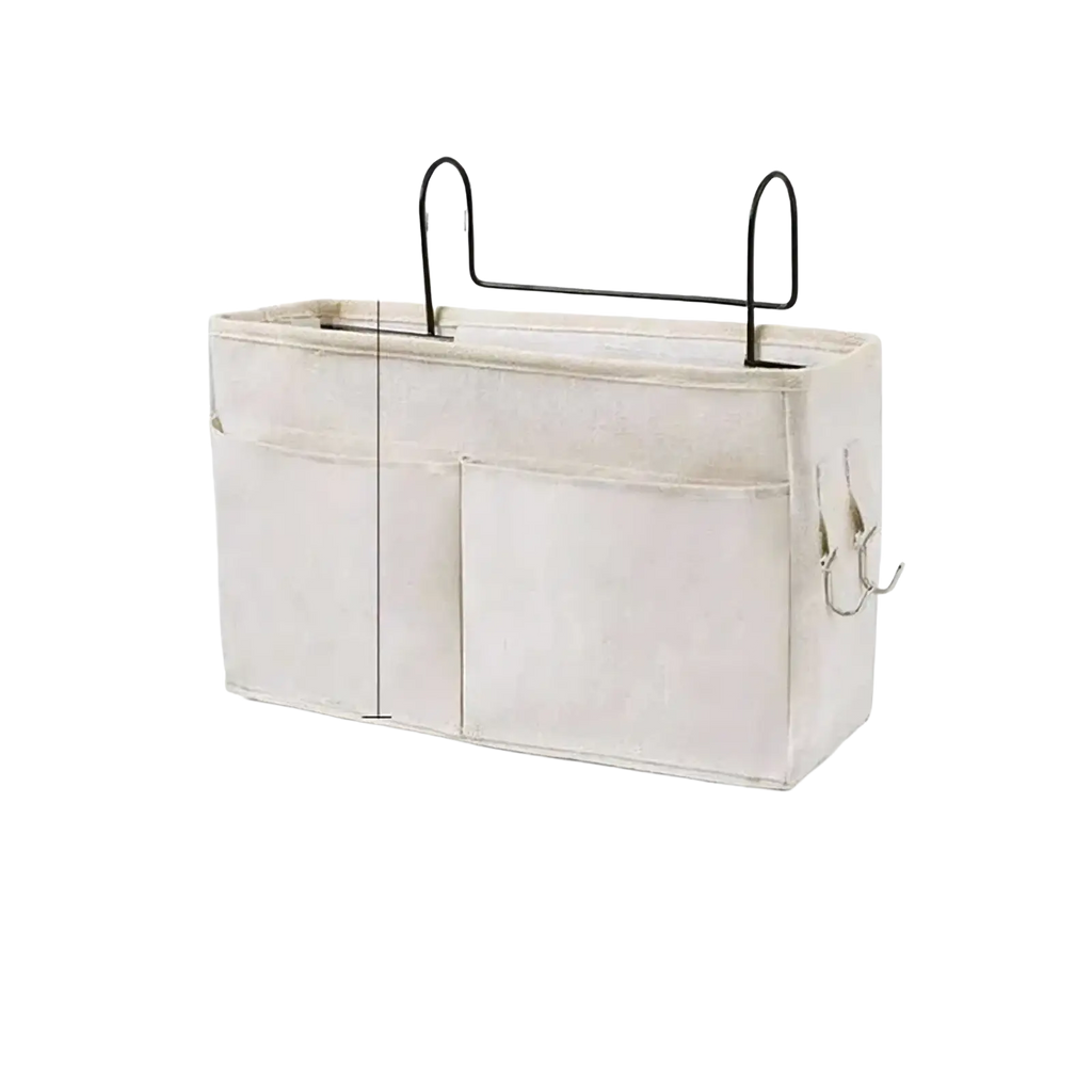 Beige linen bedside storage caddy hanging organizer with black metal handles and hooks for easy bedside storage