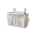 Beige linen bedside storage caddy hanging organizer with black metal hooks and side pockets for fabric overhead use