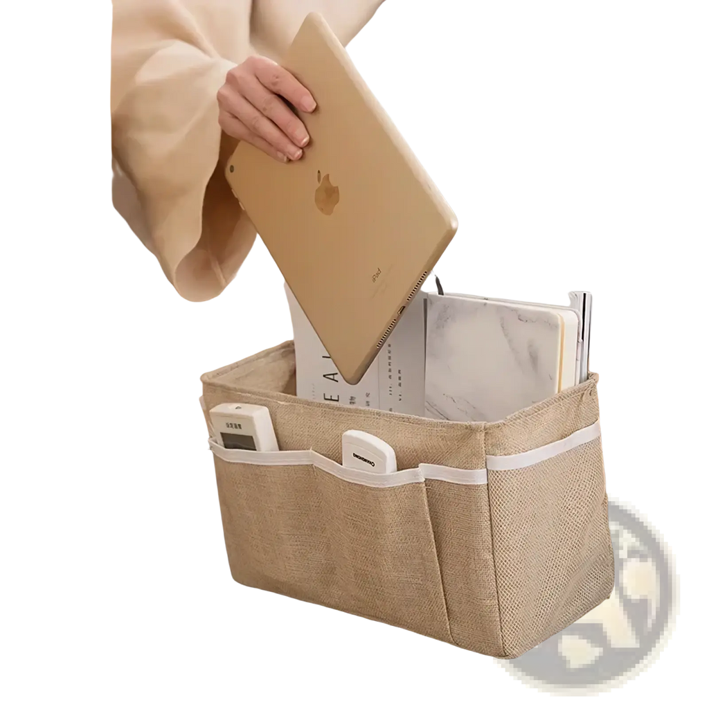 Beige woven fabric bedside storage caddy with white trim and multiple compartments for nursery organization