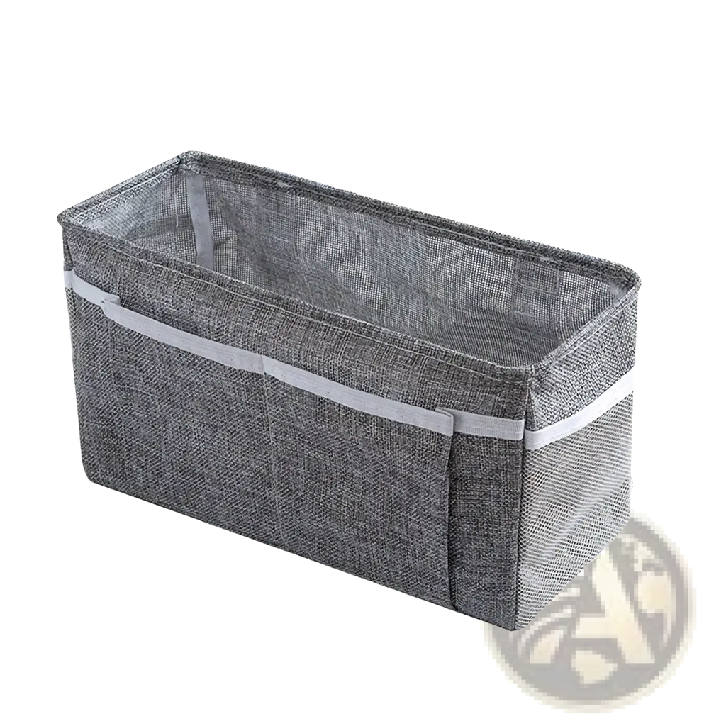 Gray textured fabric bedside storage caddy with white adhesive hooks and gray elastic band for nursery organization