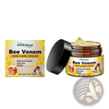 Bee venom skin care cream in a brown jar with black lid featuring honeycomb packaging and golden cream inside