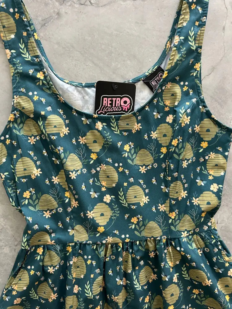 Vintage teal beehive floral cotton sleeveless fit and flare dress with yellow white and green pattern