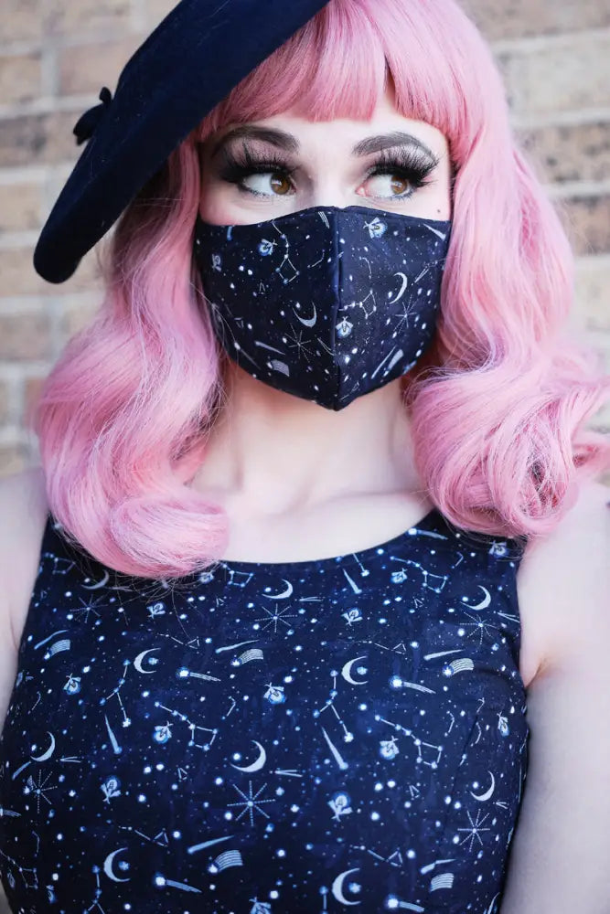 Black reversible beehive and celestial nocturnal cotton face mask with white stars moons and constellation patterns
