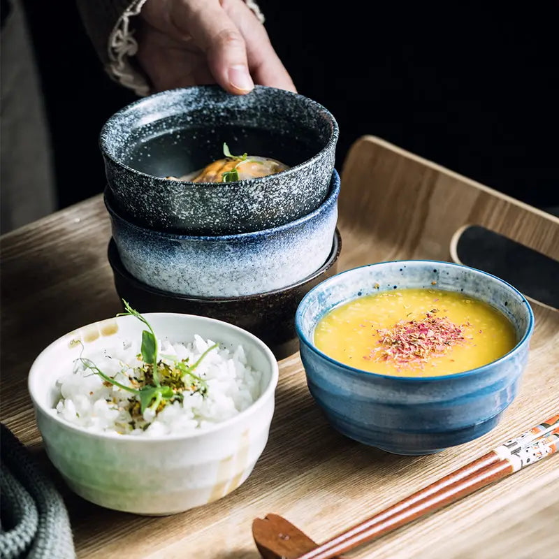 Stylish ceramic bowls in varying shades of blue and white with a speckled glaze finish ideal for retro porcelain rice tableware measuring four inches.
